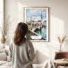 03 - Framed Zurich Switzerland Watercolor Wall Art - In Living Room with Woman Looking at it - Portrait.jpg